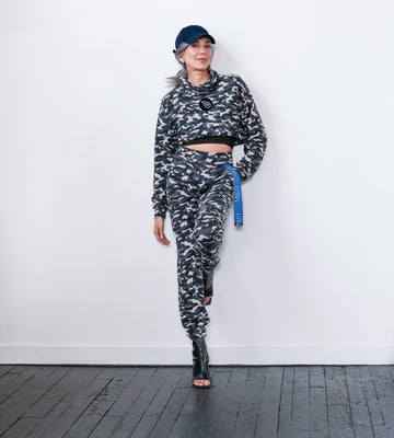 This jogger has a camo print and a comfortable yoga-style waistband that adjusts easily. It features a ribbon with the team name script attached to the left hip for a touch of team spirit.