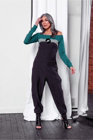 Off shoulder jumpsuit with green sleeves, white stripe, black body, and Eagles logo on the center of the chest with front patch pockets.