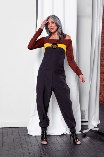 Off shoulder jumpsuit with burgundy sleeves, gold stripe, black body, and Commanders logo on the center of the chest with front patch pockets.